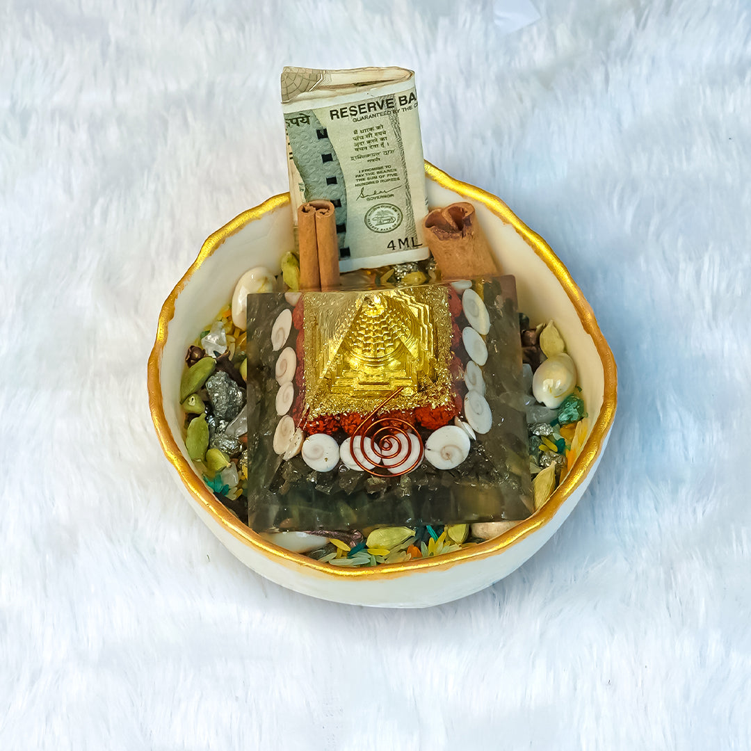 Small altar with various items including a Shree Yantra pyramid, money, and crystals